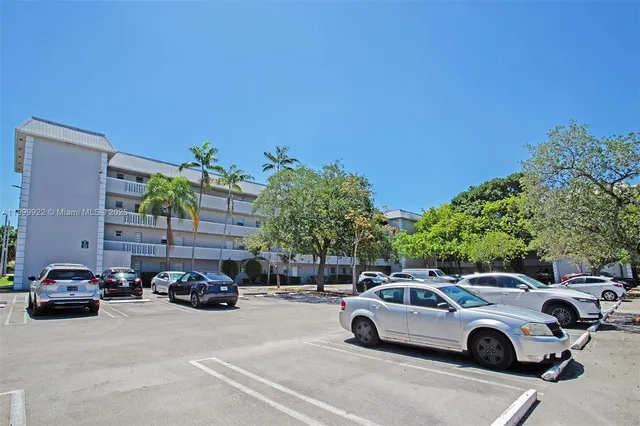 a view of cars parked in front of a house