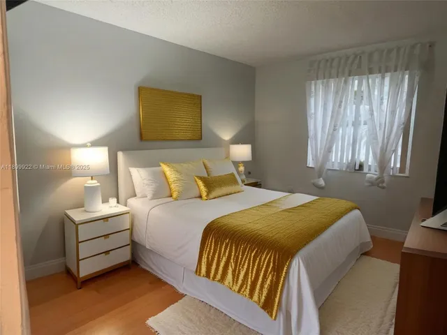 a bedroom with a bed and a lamp