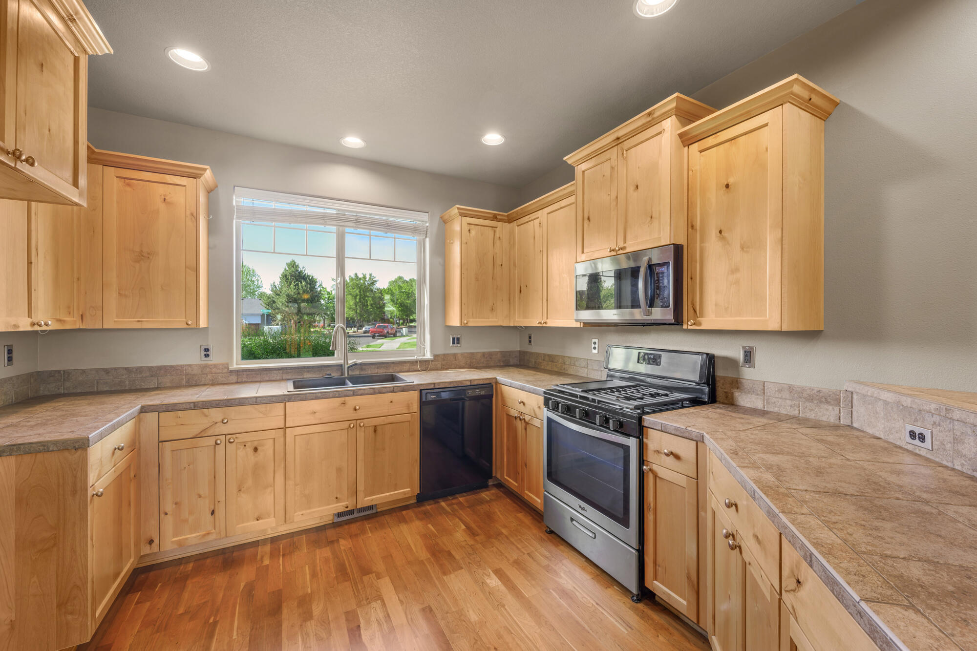1402 Northeast Hudspeth Road Prineville, OR 97754 - Photo 11 of 36 a kitchen with a sink stove and cabinets