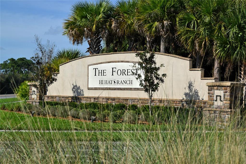 10709 Leafwing Drive Sarasota, FL 34241 - Photo 27 of 27 a sign of golf club on a wall under a tree