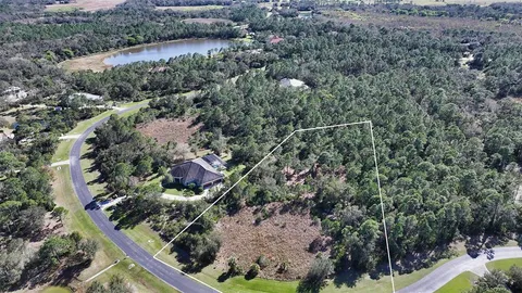 an aerial view of house with a yard