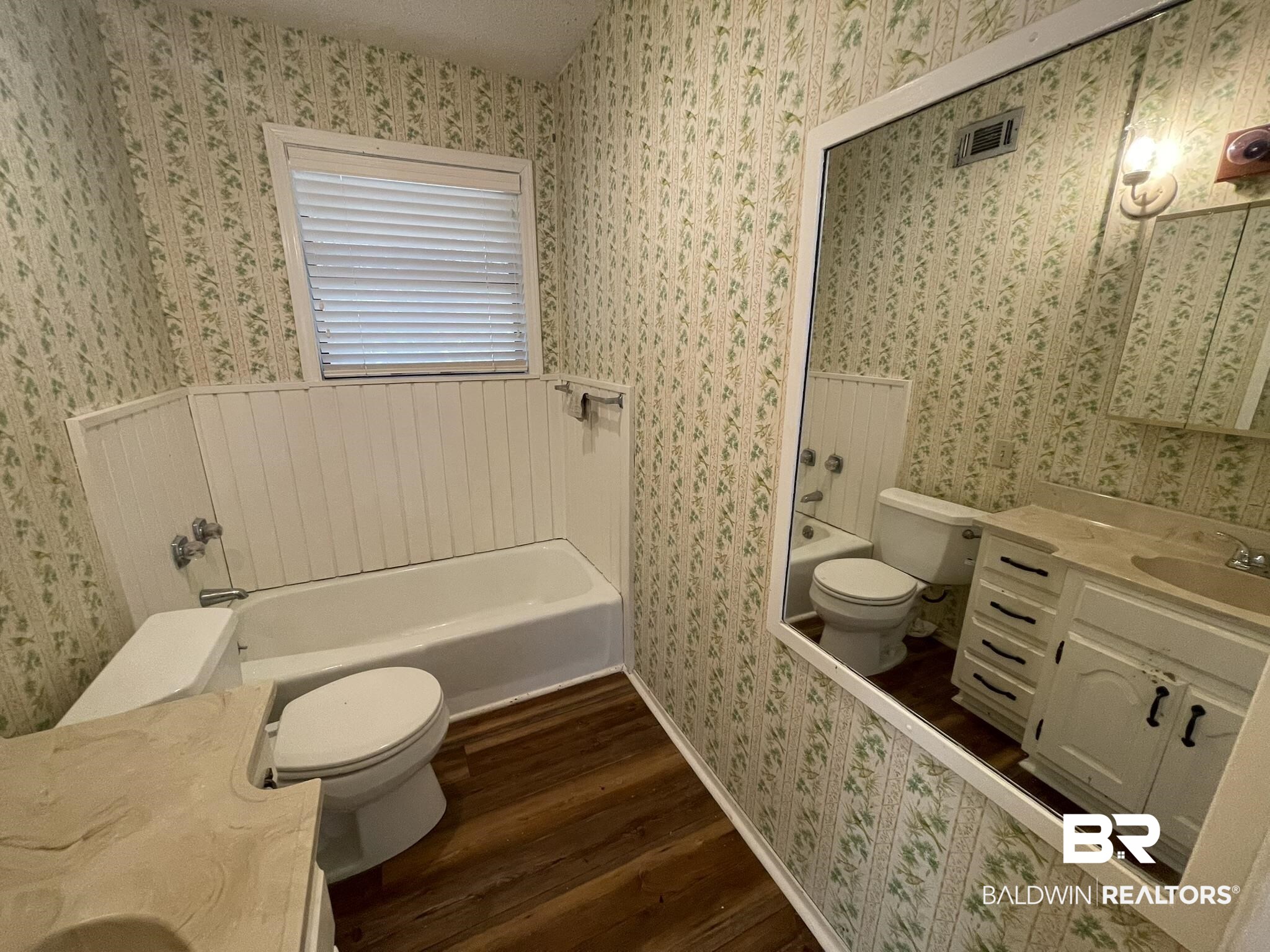 6621 Purvis Road Daphne, AL 36527 - Photo 46 of 59 Full bathroom with vanity, dark wood-type flooring, wallpapered walls, and shower / tub combination
