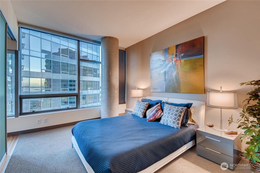 2033 2nd Avenue, Unit 1608 Seattle, WA 98121 - Photo 13 of 33 a bed room with a bed and a large window