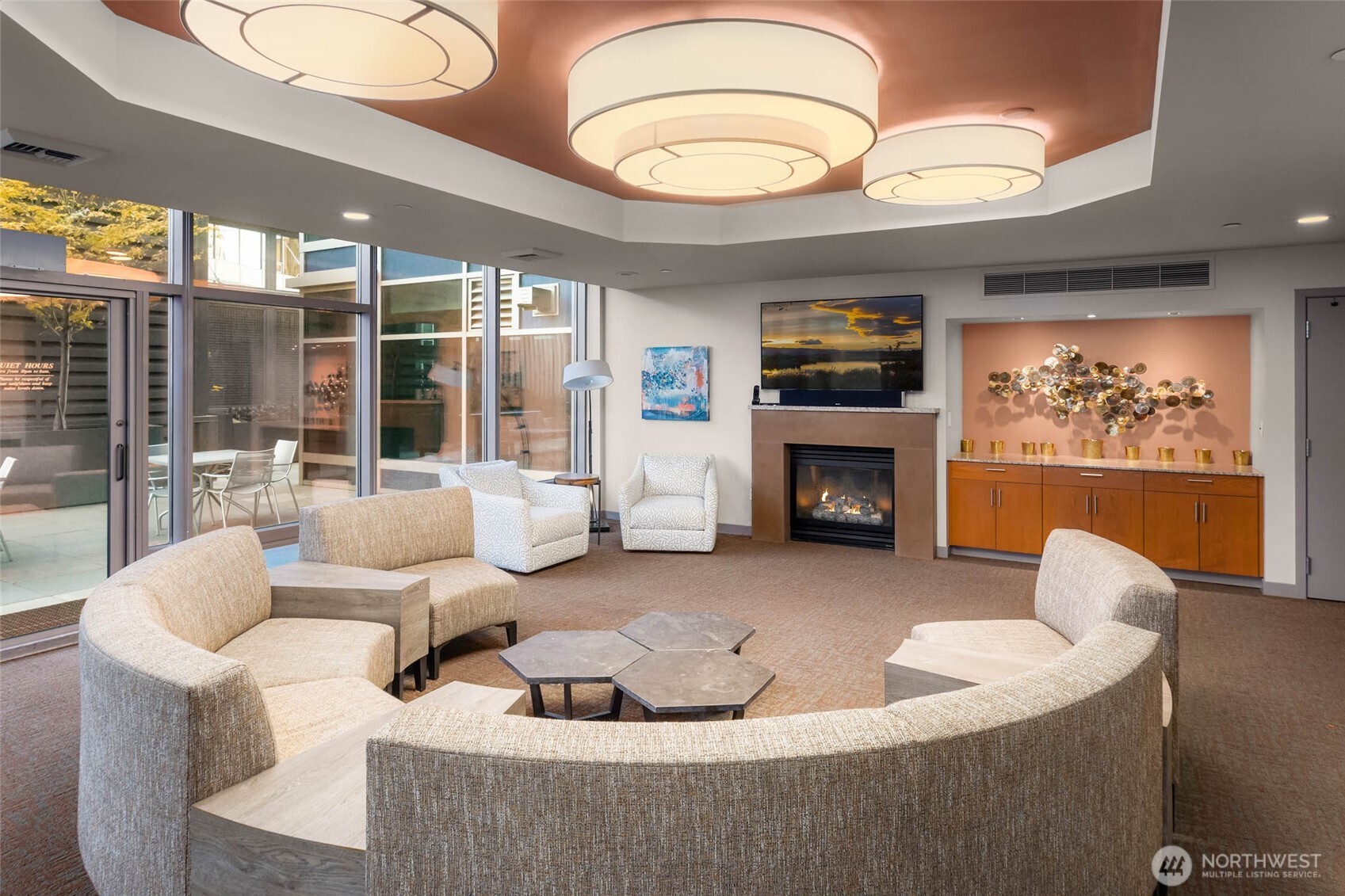 2033 2nd Avenue, Unit 1608 Seattle, WA 98121 - Photo 25 of 33 a living room with furniture a flat screen tv and a fireplace