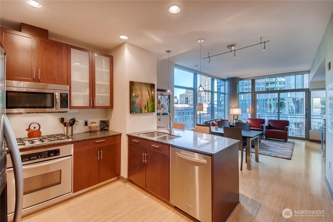 2033 2nd Avenue, Unit 1608 Seattle, WA 98121 - Photo 8 of 33 a kitchen with lots of counter top space a sink appliances and cabinets