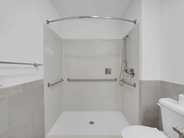 a bathroom with a shower and toilet