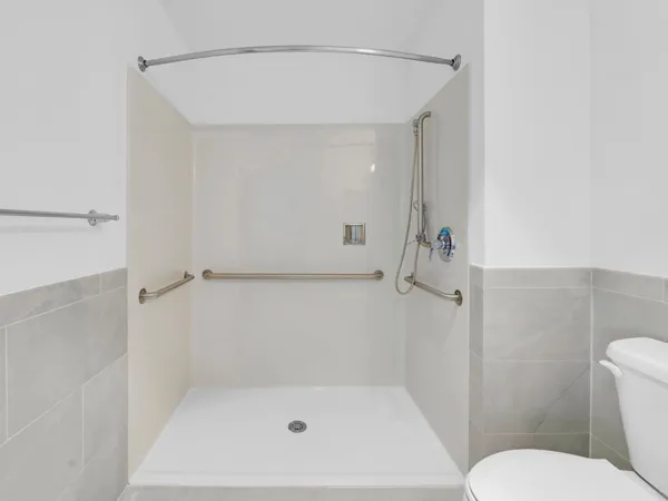 a bathroom with a shower and toilet