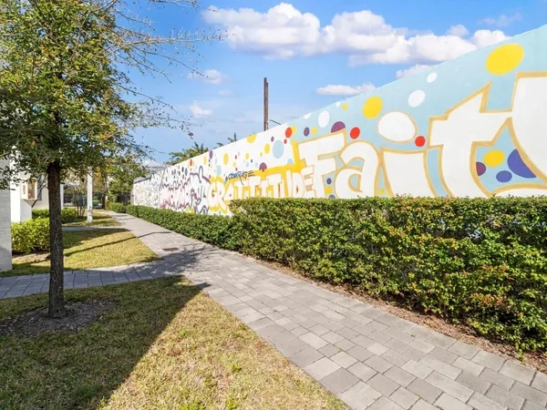 a view of a park with iron fence