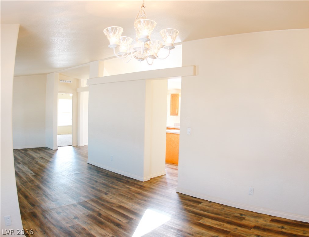 5231 Ruby Way Caliente, NV 89008 - Photo 14 of 35 Laminate flooring flows through this open concept interior, illuminated by a decorative chandelier.
