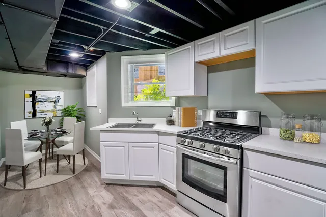 a kitchen with stainless steel appliances granite countertop a stove and a sink