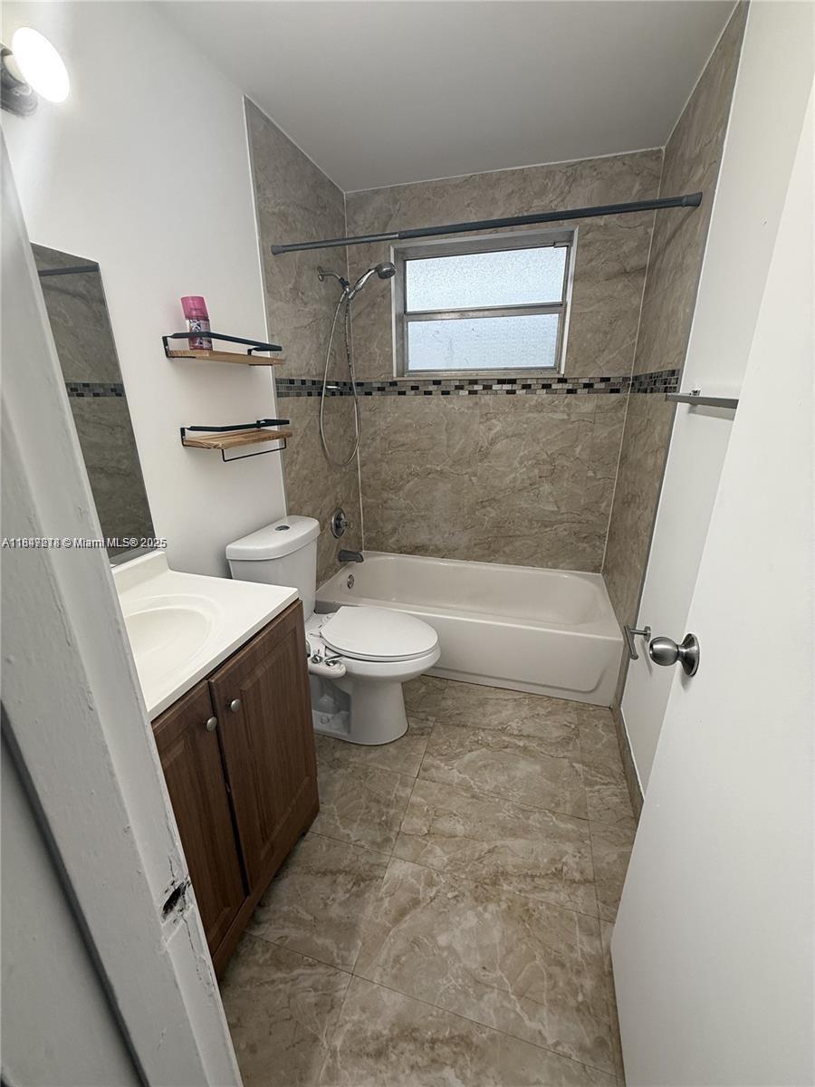 7505 Southwest 82nd Street, Unit 314 Miami, FL 33143 - Photo 8 of 9 a bathroom with a sink a toilet and a shower