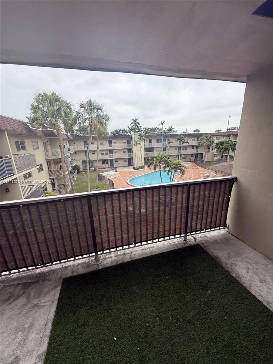7505 Southwest 82nd Street, Unit 314 Miami, FL 33143 - Photo 9 of 9 a view of a roof deck with wooden floor and fence
