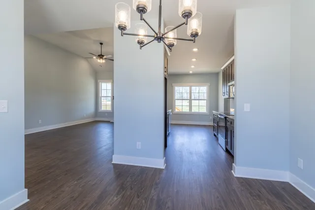 a kitchen with kitchen island granite countertop a sink a counter space and stainless steel appliances