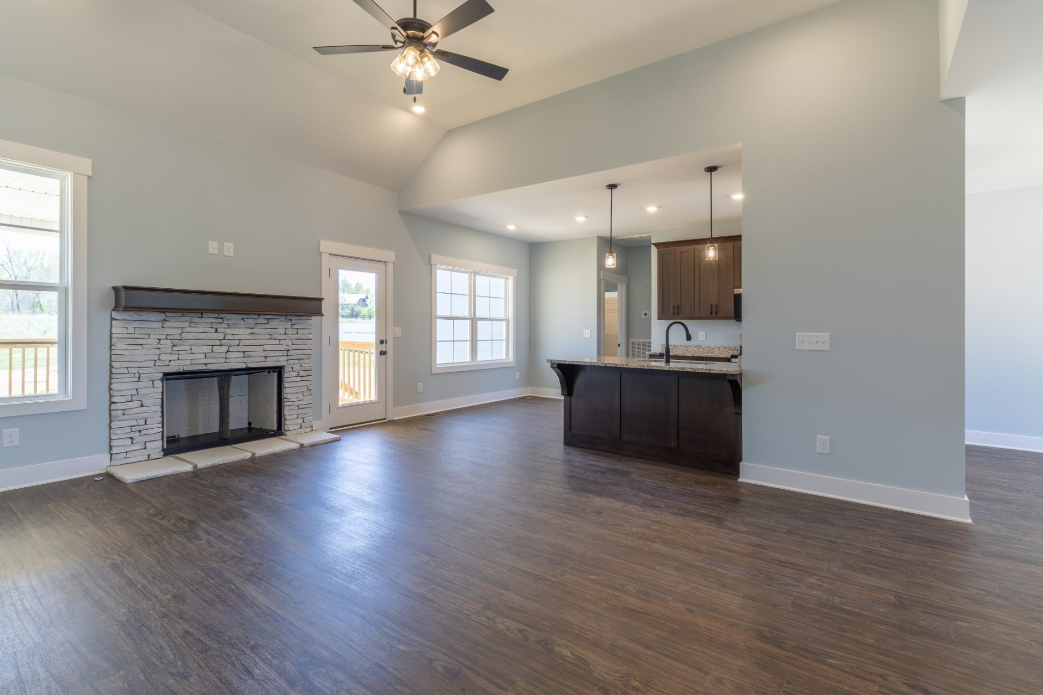 2060 Beverly Court Springfield, TN 37172 - Photo 14 of 33 an empty room with wooden floor fireplace and windows