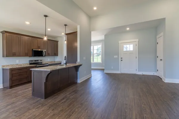 a kitchen with kitchen island a sink stainless steel appliances and cabinets