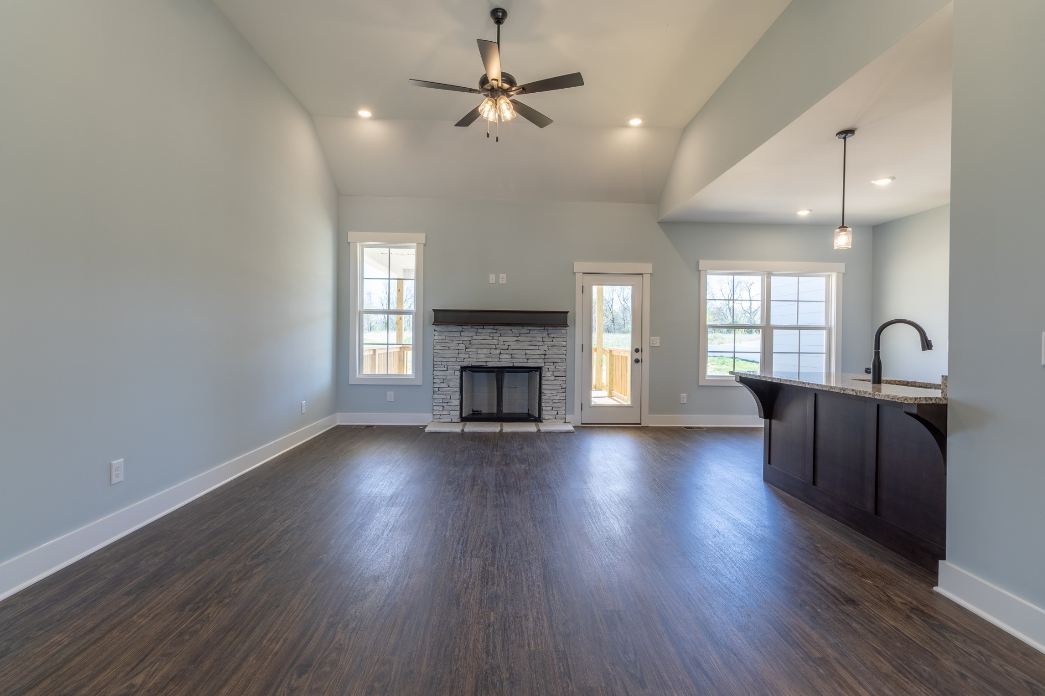 2060 Beverly Court Springfield, TN 37172 - Photo 10 of 33 an empty room with wooden floor fireplace and windows