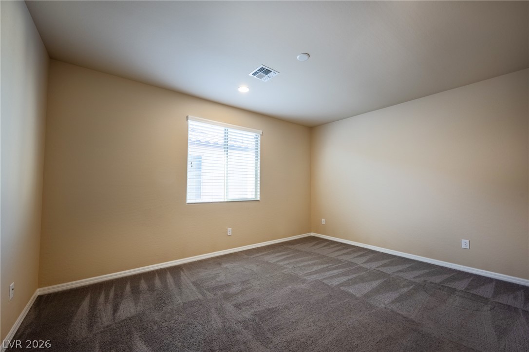 11016 Prairie Grove Road Las Vegas, NV 89179 - Photo 23 of 37 A well-lit room offers fresh carpet and ample natural light through a single window.