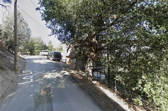 a view of dirt road with trees