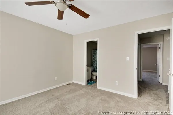 a view of a livingroom with a ceiling fan and window
