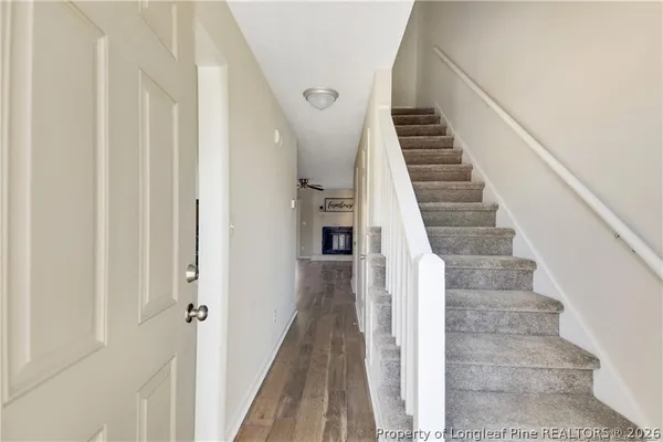 a view of entryway and hall with wooden floor