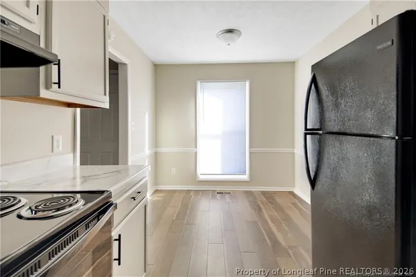 a kitchen with a refrigerator and a stove