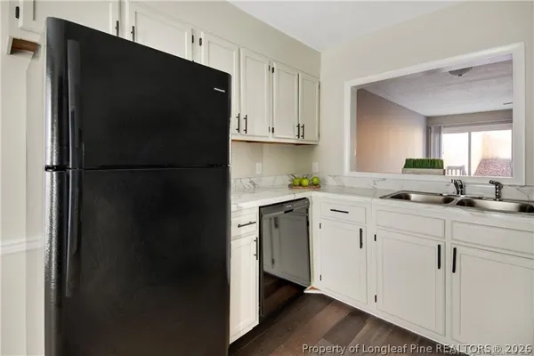 a kitchen with a refrigerator and cabinets