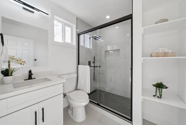 a bathroom with a sink toilet vanity and tub