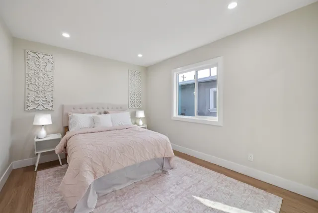 a bedroom with a bed and a large mirror