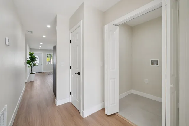 a bedroom with a bed and a potted plant