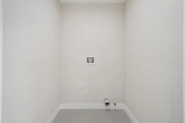 a view of a white house with wooden fence