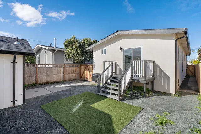 a view of a house with a backyard and a garden