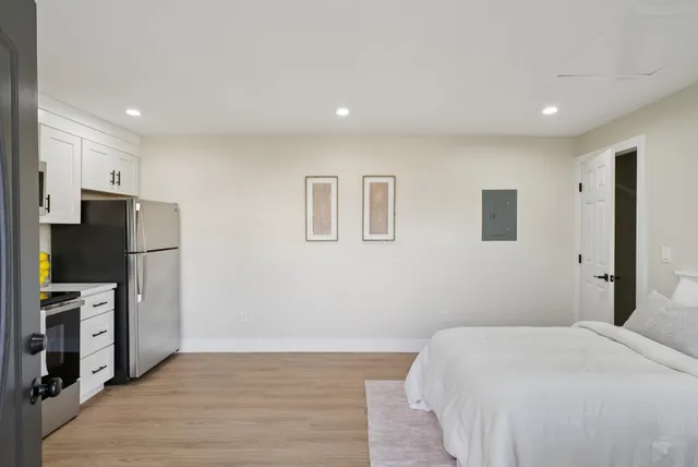 a kitchen with cabinets stainless steel appliances and a window
