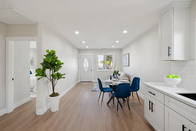 a living room with furniture and a potted plant