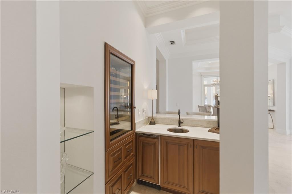 361 Pirates Bight Naples, FL 34103 - Photo 14 of 45 a bathroom with a double vanity sink and mirror