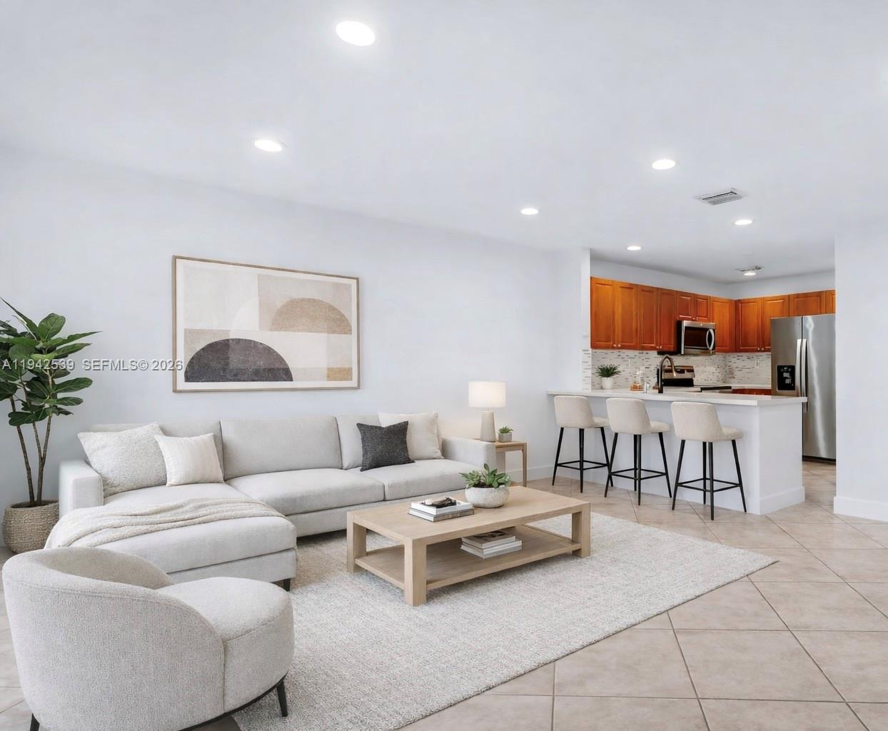 a living room with furniture and kitchen view