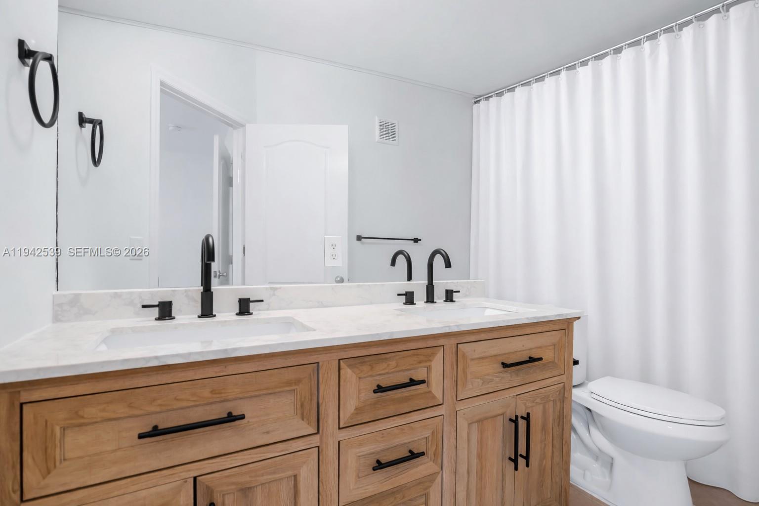 3186 Southwest 129th Terrace, Unit 113 Miramar, FL 33027 - Photo 11 of 29 a bathroom with a sink and a toilet