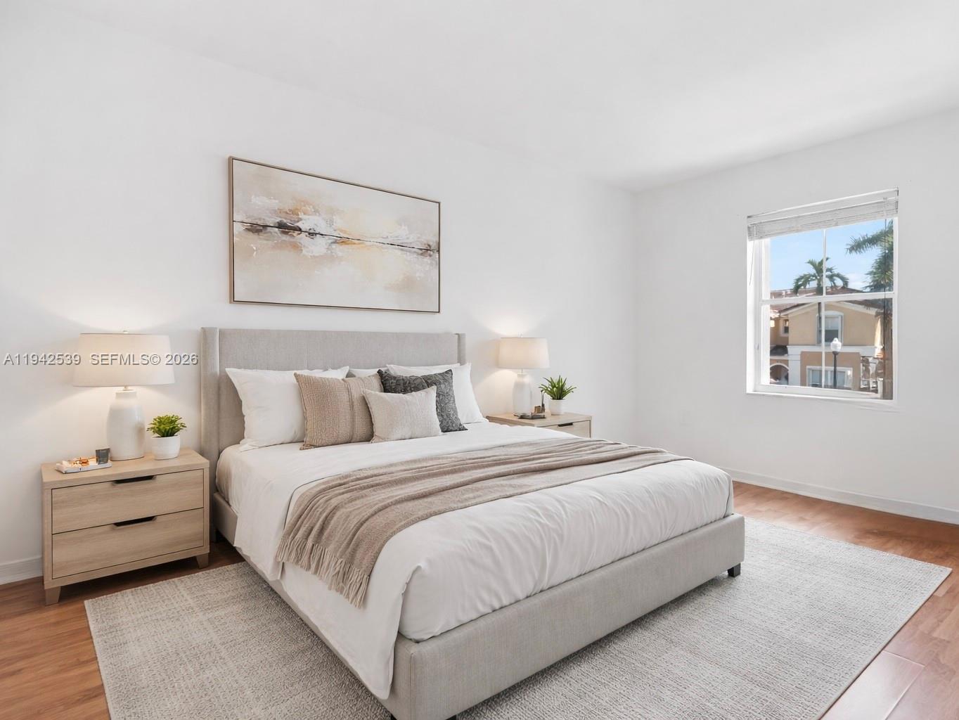 3186 Southwest 129th Terrace, Unit 113 Miramar, FL 33027 - Photo 12 of 29 a bedroom with a bed and a painting on the wall