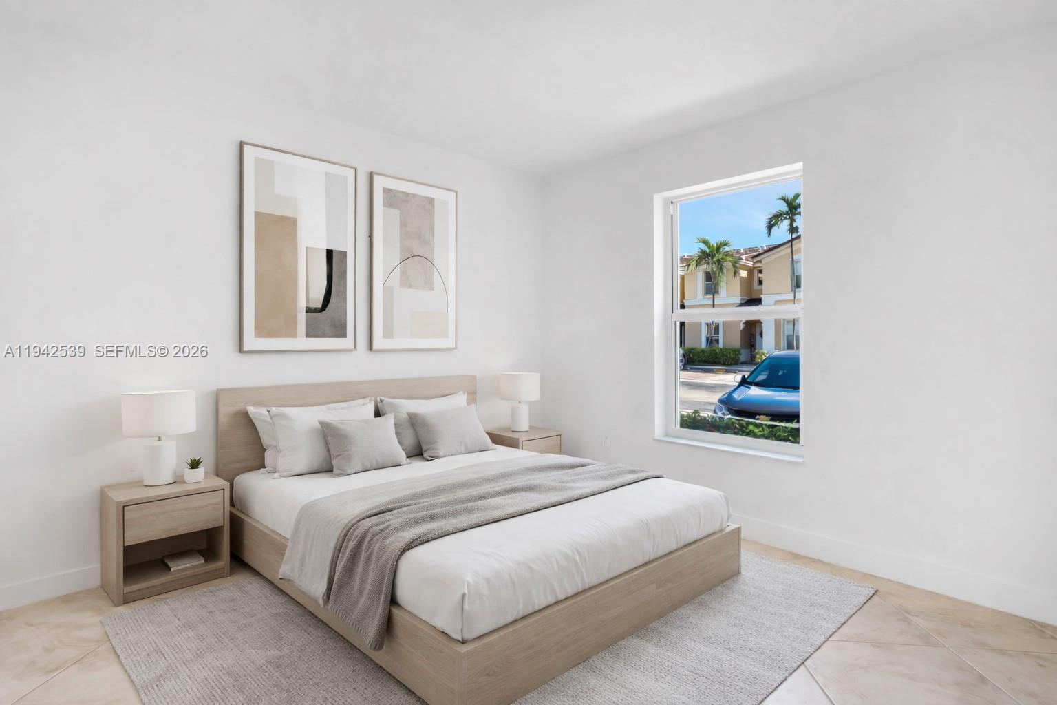 3186 Southwest 129th Terrace, Unit 113 Miramar, FL 33027 - Photo 15 of 29 a bedroom with a bed and a window