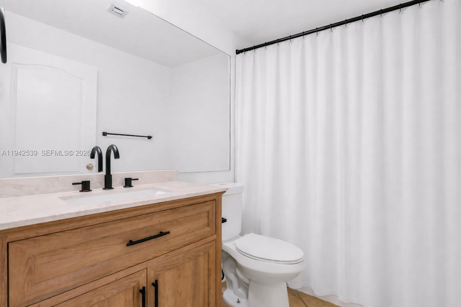3186 Southwest 129th Terrace, Unit 113 Miramar, FL 33027 - Photo 16 of 29 a bathroom with a sink and a mirror