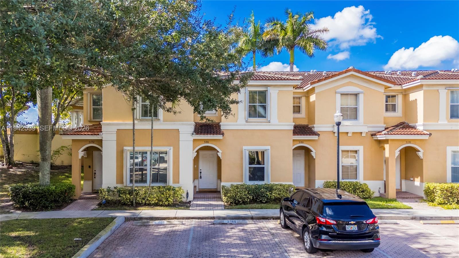 3186 Southwest 129th Terrace, Unit 113 Miramar, FL 33027 - Photo 19 of 29 a front view of a house with a garden