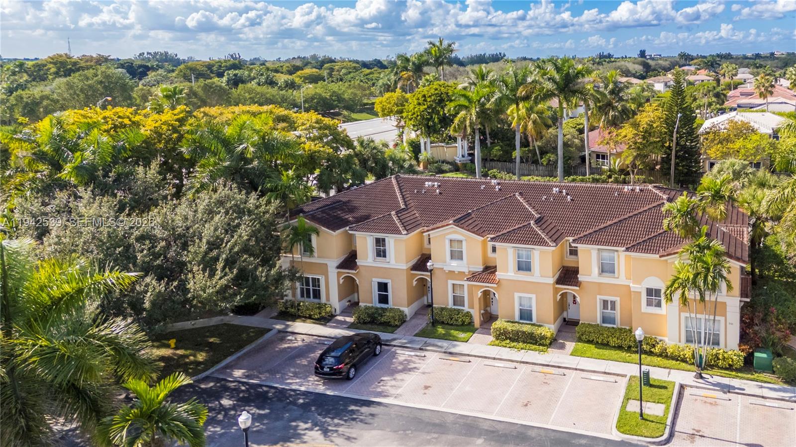 3186 Southwest 129th Terrace, Unit 113 Miramar, FL 33027 - Photo 21 of 29 an aerial view of multiple houses with a yard