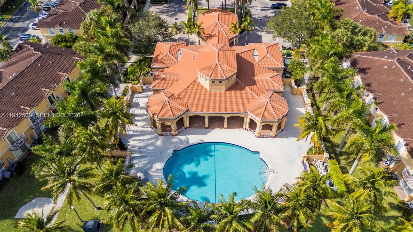 3186 Southwest 129th Terrace, Unit 113 Miramar, FL 33027 - Photo 25 of 29 an aerial view of a house with swimming pool and wooden bench