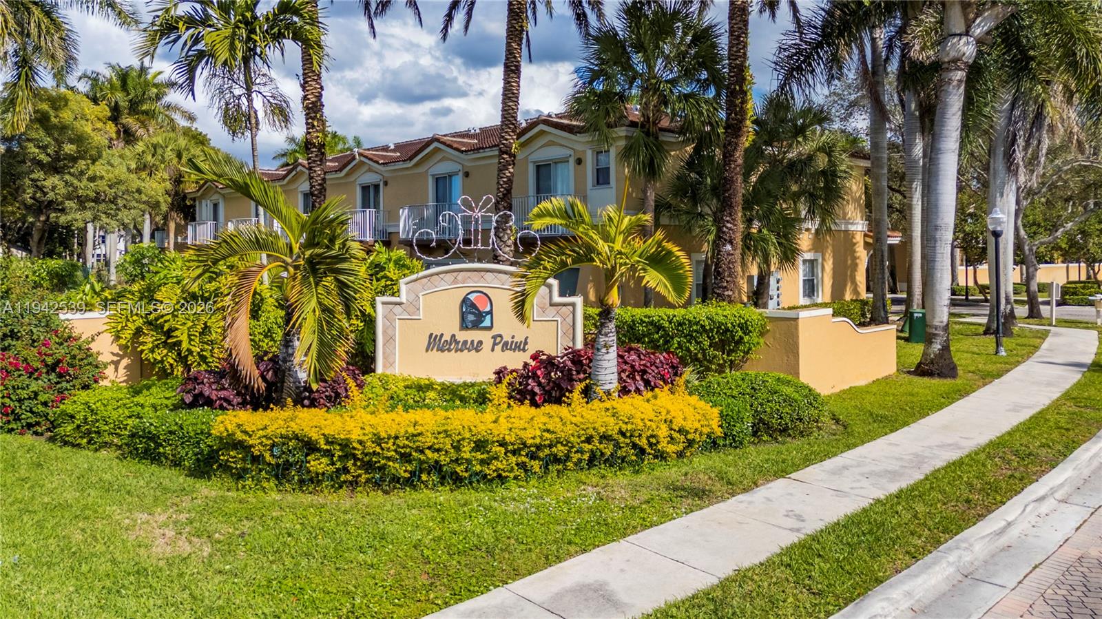 3186 Southwest 129th Terrace, Unit 113 Miramar, FL 33027 - Photo 26 of 29 a front view of a house with a yard