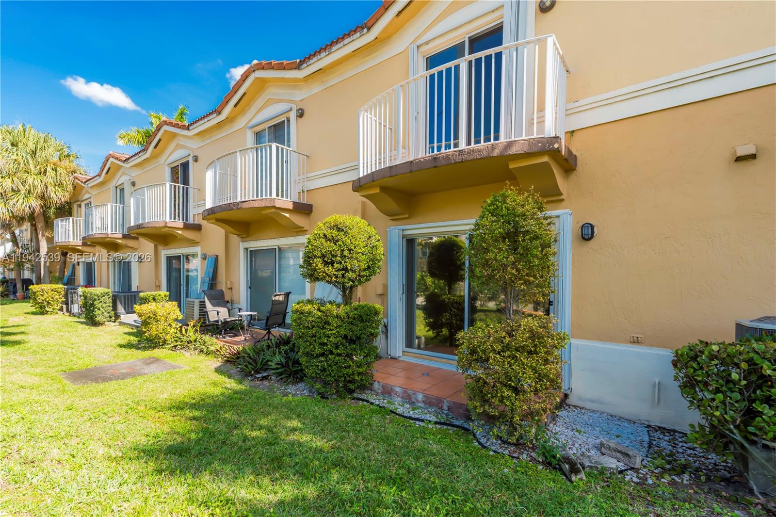 3186 Southwest 129th Terrace, Unit 113 Miramar, FL 33027 - Photo 27 of 29 a front view of a house with a yard