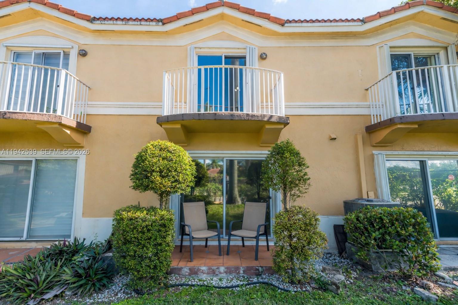 3186 Southwest 129th Terrace, Unit 113 Miramar, FL 33027 - Photo 7 of 29 a front view of a house with garden