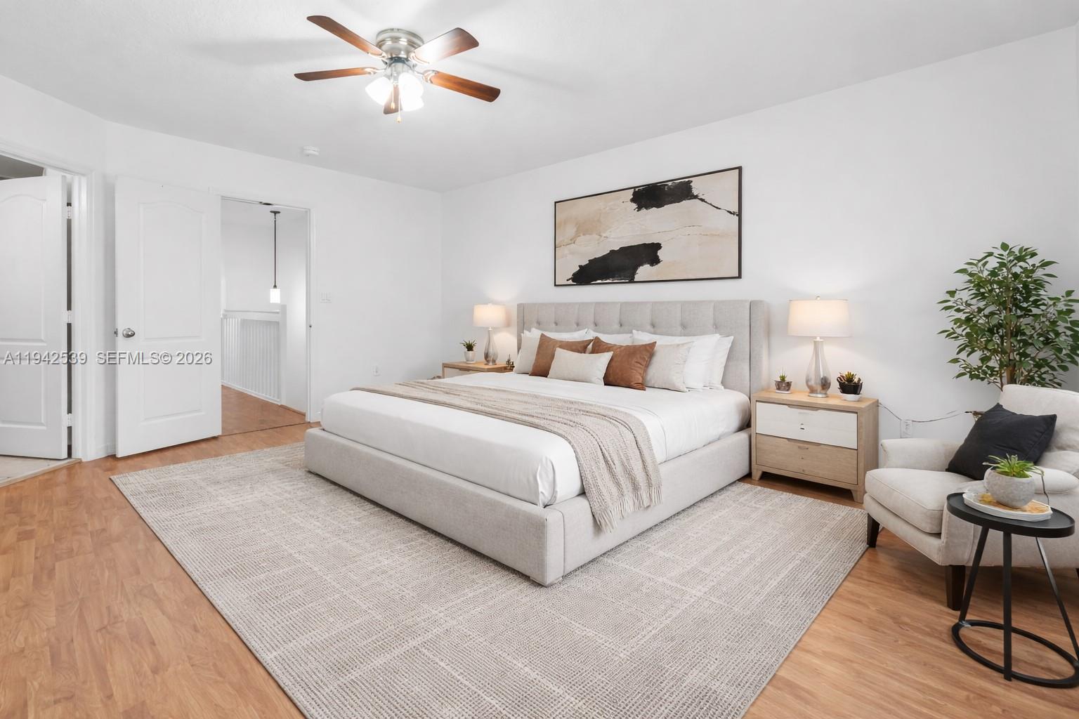 3186 Southwest 129th Terrace, Unit 113 Miramar, FL 33027 - Photo 8 of 29 a spacious bedroom with a bed and a chandelier