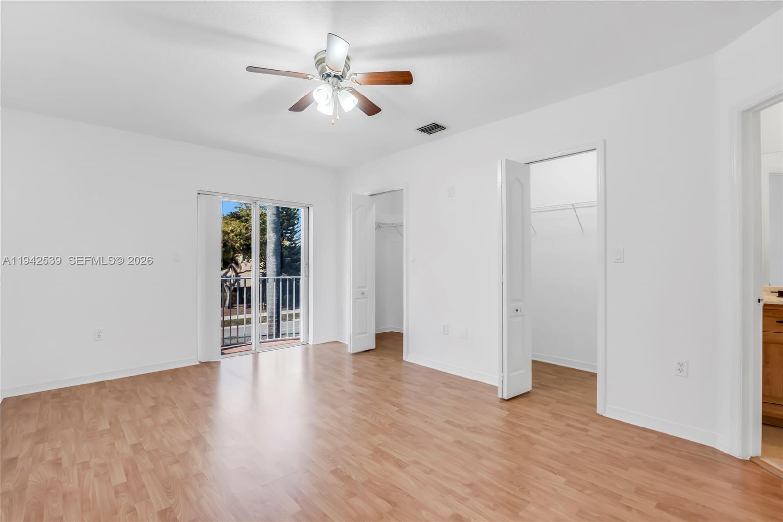 3186 Southwest 129th Terrace, Unit 113 Miramar, FL 33027 - Photo 9 of 29 wooden floor in an empty room with a window
