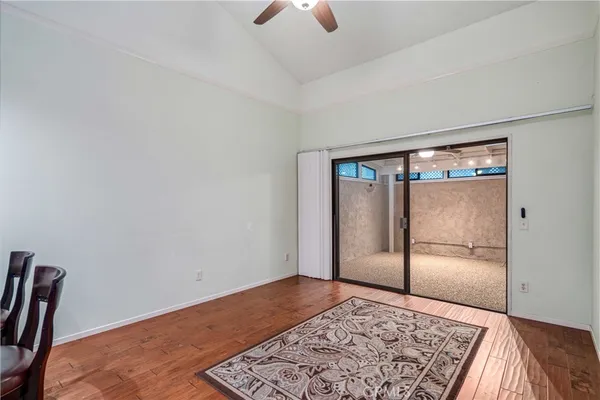 a view of an empty room with a window and a ceiling fan
