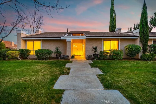 a front view of a house with swimming pool having outdoor seating