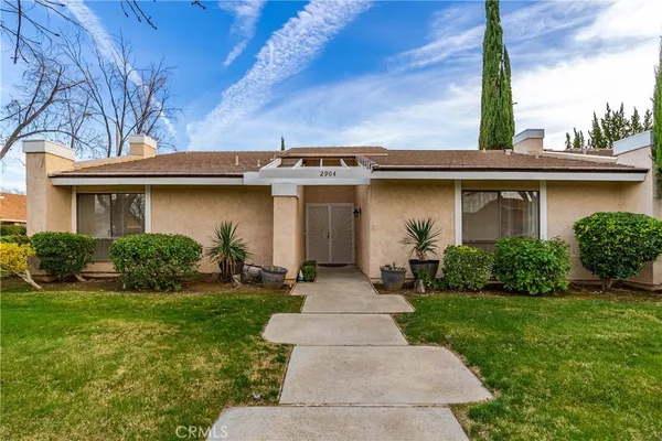 a hallway with potted plants in front of door